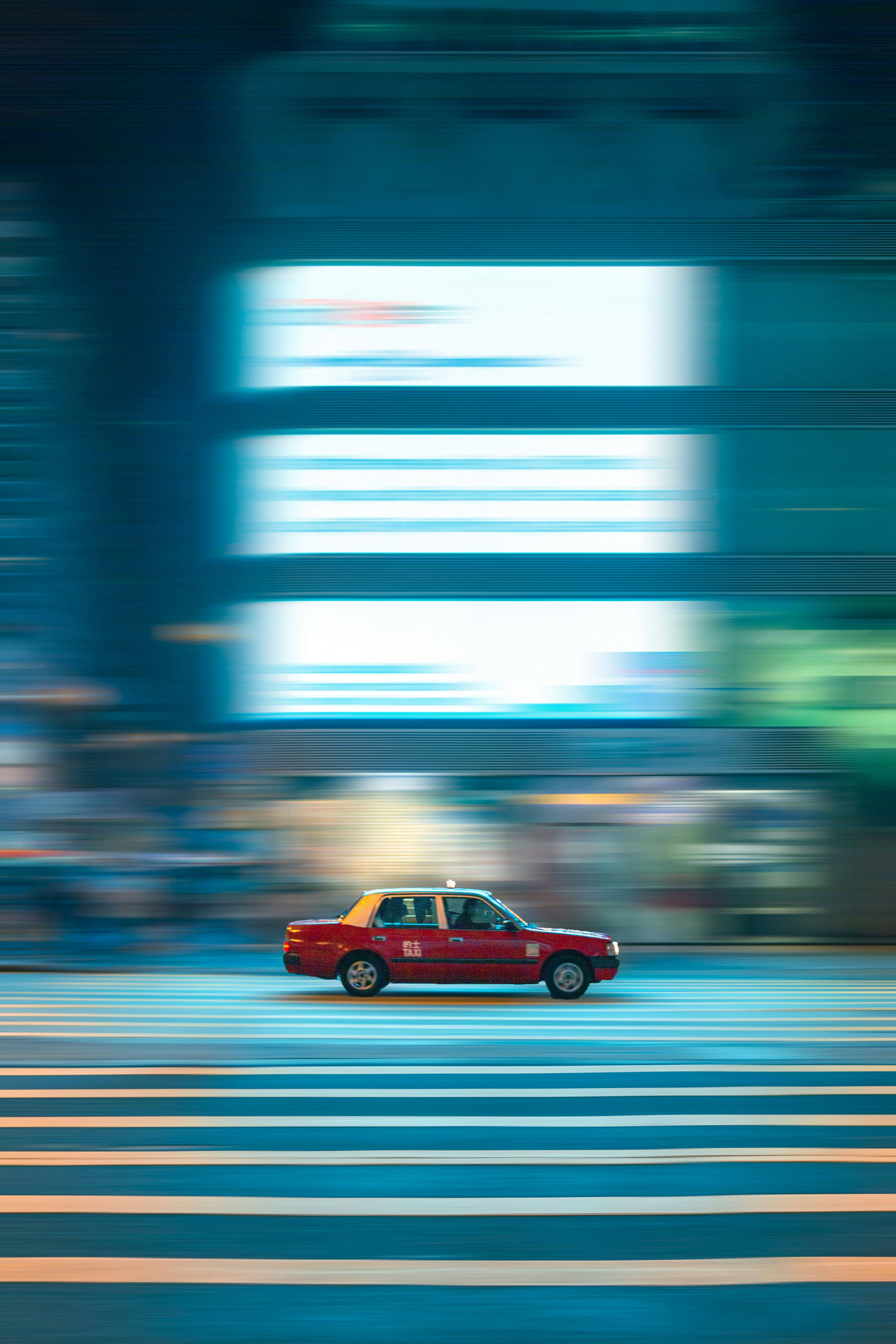 red sedan on road during daytime